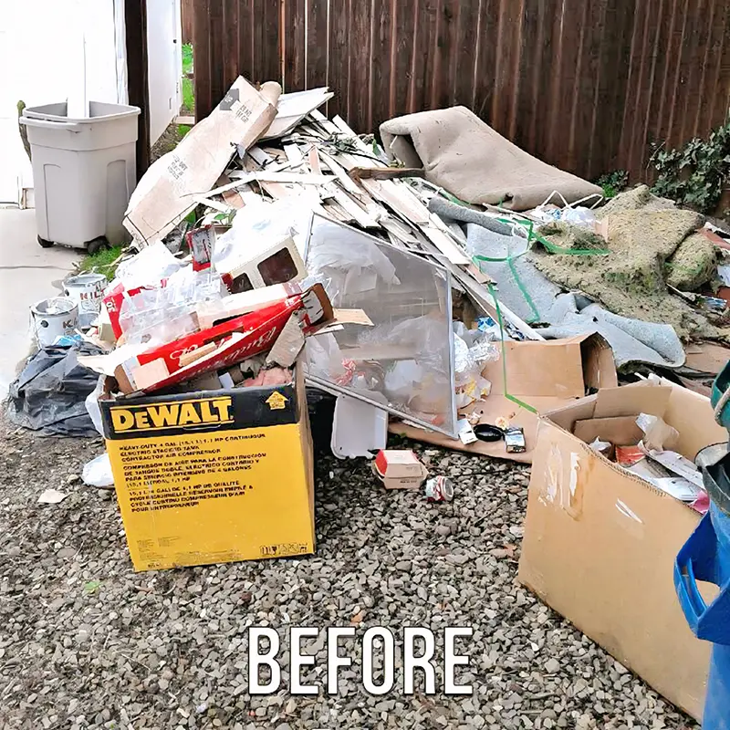 A Santa Barbara yard piled with junk, cardboard, and debris before an Express Hauling cleanout